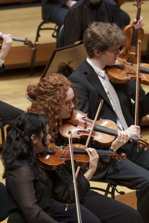 A closeup of two Civic Orchestra of Chicago violinists