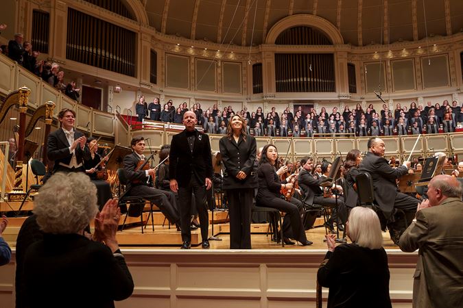 Guest Chorus Director James Bass and Artistic Director of Uniting Voices Chicago Josephine Lee bowing on stage