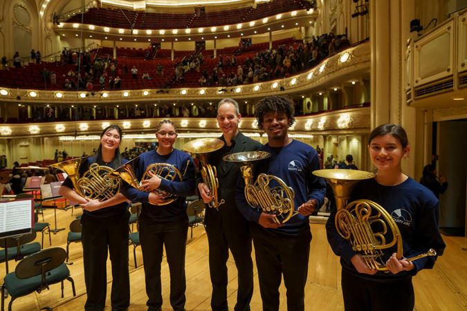horns posing on stage