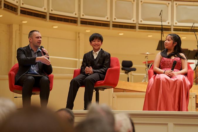 WFMT's Robbie Ellis asking a question to the four 2025 Young Artists Competition finalists at a postconcert Q&A session