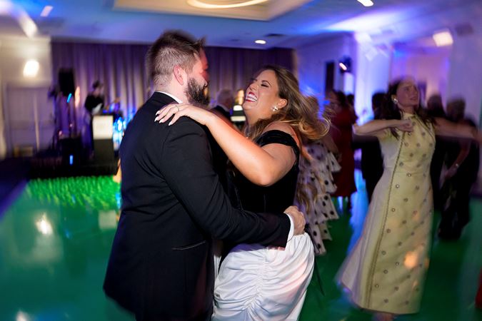 Two gala attendees dancing on the dance floor and smiling