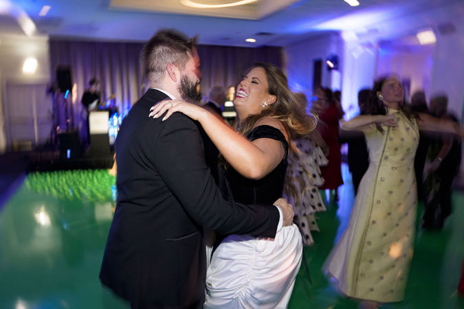 Two gala attendees dancing on the dance floor and smiling