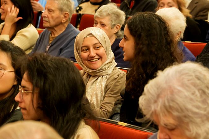 two young audience members converse before the concert