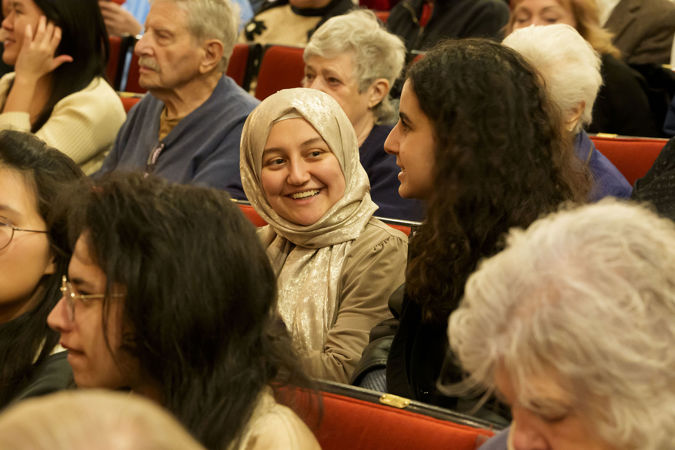 two young audience members converse before the concert