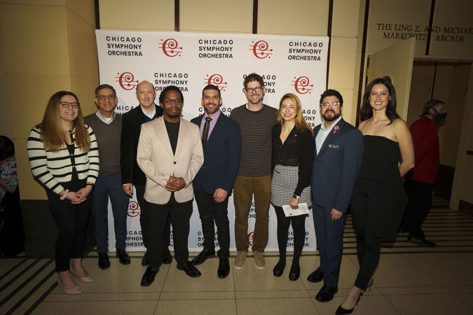composers Quinn Mason, Jimmy López and Adam Schoenberg pose in front of a CSO-branded backdrop with six Latino Alliance members