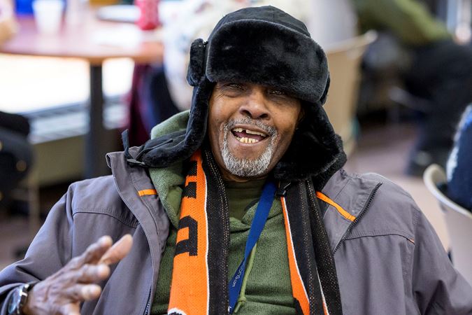 A community member from the Southwest Regional Senior Center smiling during the 2025 Bach Marathon performance