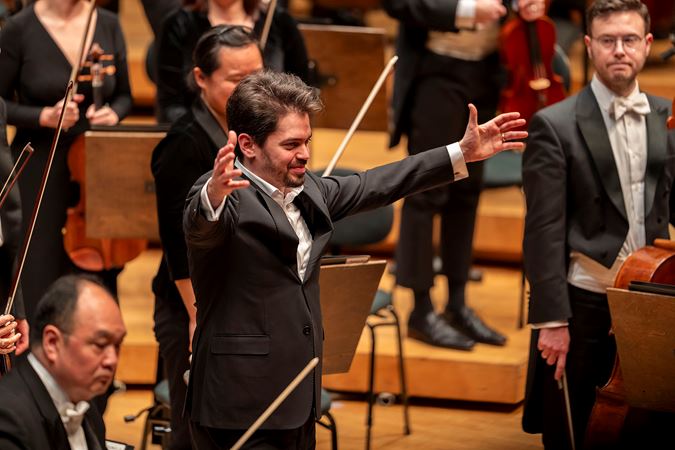 Shani stretches his arms for a bow