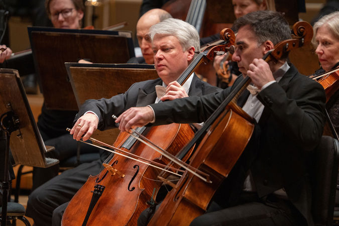 Closeup of CSO cellos Richard Hirschl and Kenneth Olsen on stage