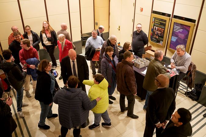 Sam Quinones, author of The Perfect Tuba, signs copies of his book in a crowded Rotunda after the concert
