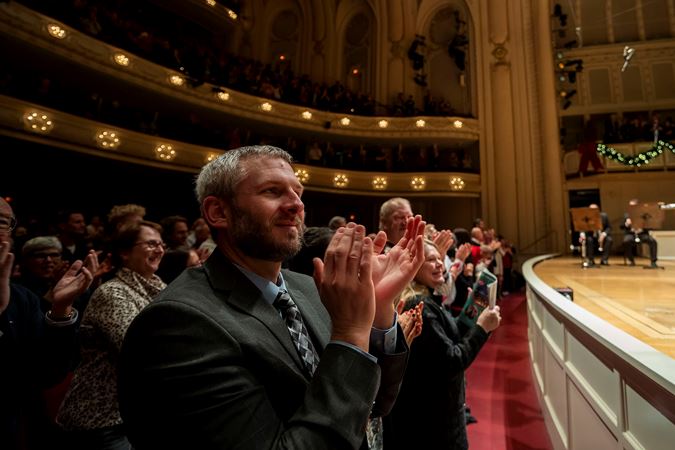 audience members on the main floor applauding