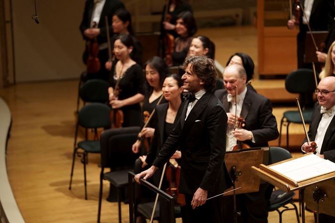 conductor Gustavo Gimeno takes a bow at the end of the performance of Ravel's suite from Daphnis and Chloe