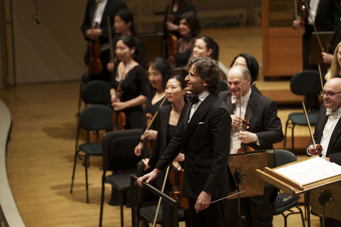 conductor Gustavo Gimeno takes a bow at the end of the performance of Ravel's suite from Daphnis and Chloe