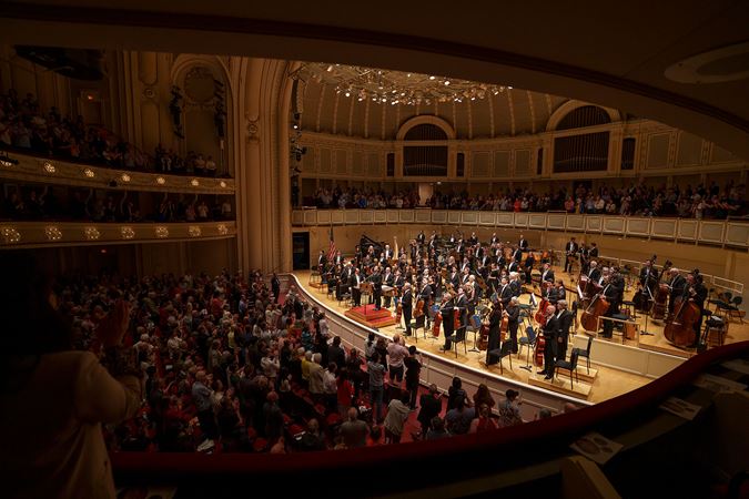 full orchestra standing