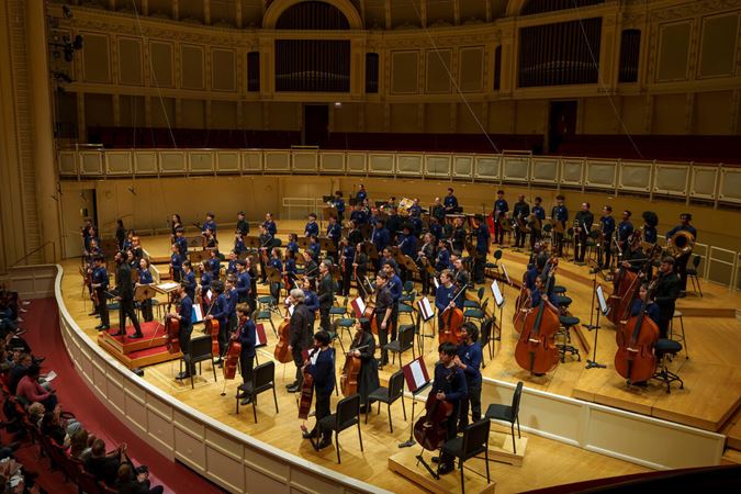 orchestra standing on stage