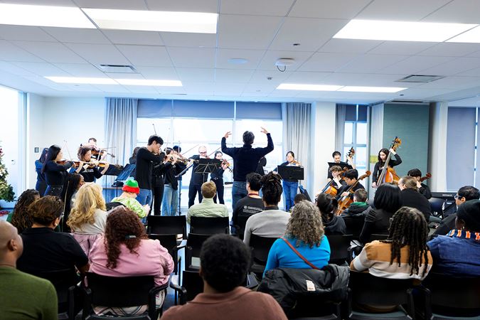 Ken-David Masur leading a Civic string ensemble at UCAN as part of the 2025 Civic Bach Marathon