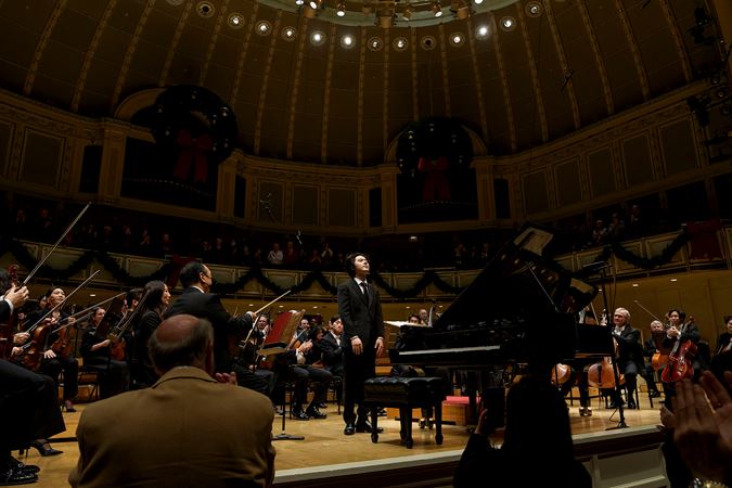 Yunchan Lim takes a solo bow next to the piano