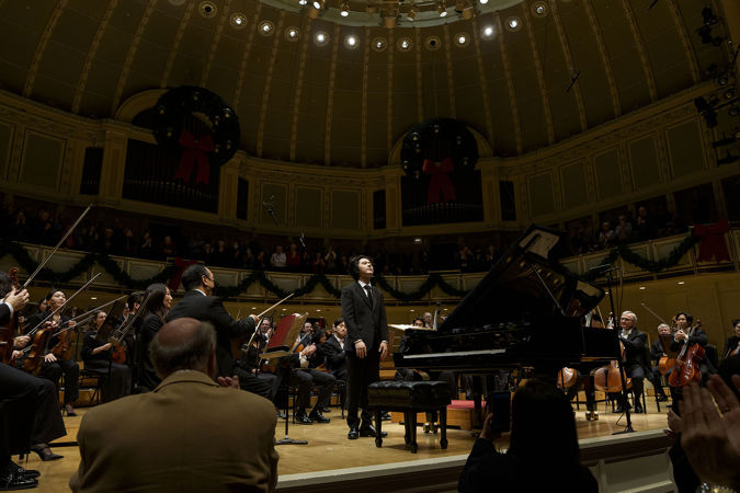 Yunchan Lim takes a solo bow next to the piano