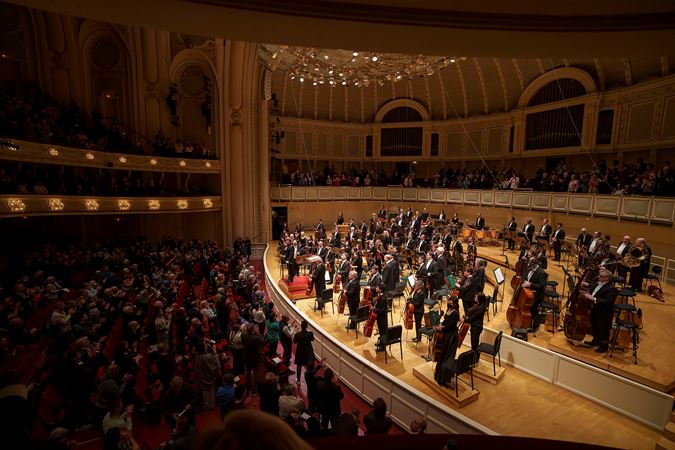 the full Orchestra bows to a cheering crowd in Orchestra Hall