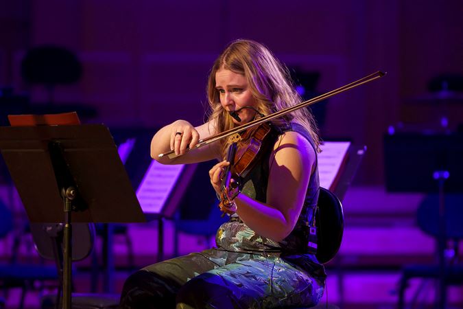 Close up of ATLYS violinist Jinty McTavish performing on stage