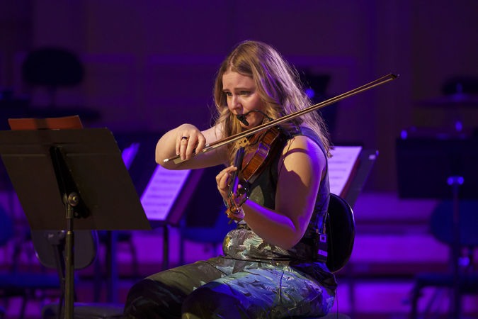 Close up of ATLYS violinist Jinty McTavish performing on stage