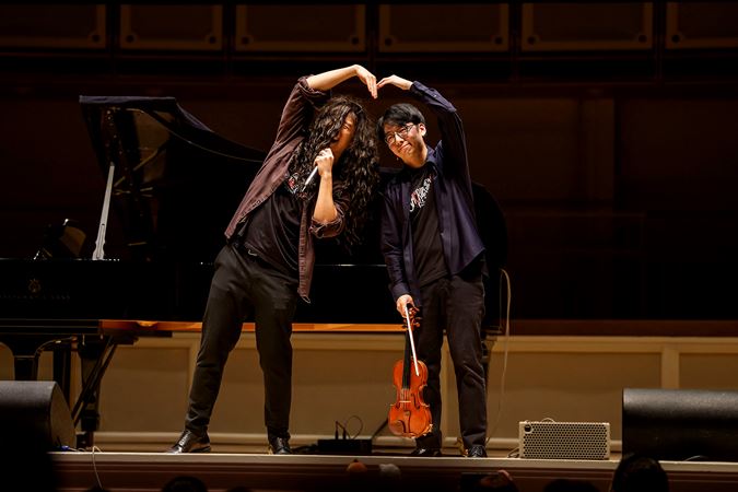 Eddy and Brett form a giant heart with their hands in the middle of a skit