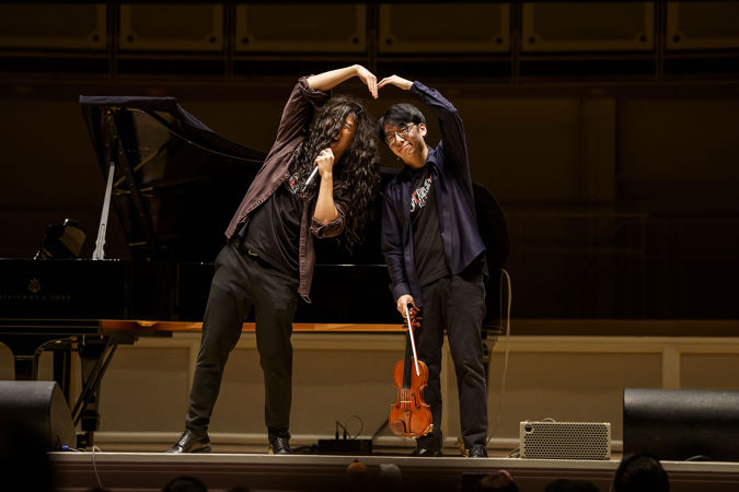 Eddy and Brett form a giant heart with their hands in the middle of a skit