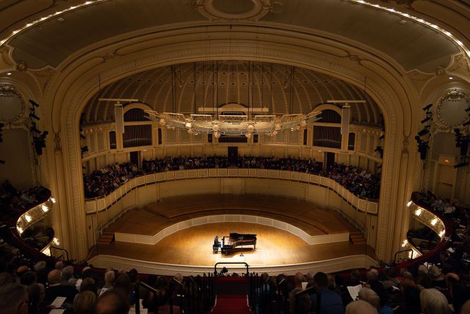 pianist on stage from upper balcony