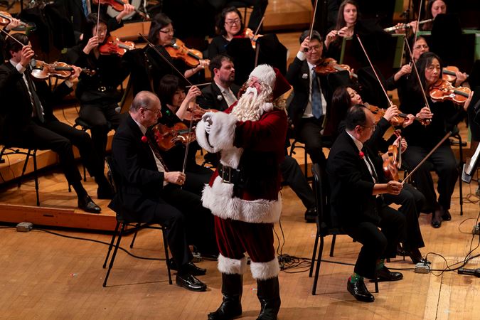 Santa Claus address the audience from on stage