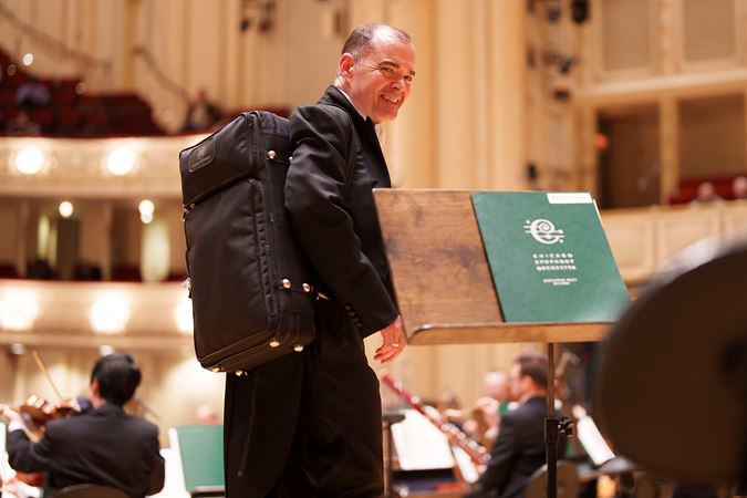 Closeup shot of CSO bassoon William Buchman walking on stage to warm up