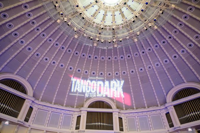 the "Tango After Dark" logo is projected on the ceiling of Orchestra Hall before the show