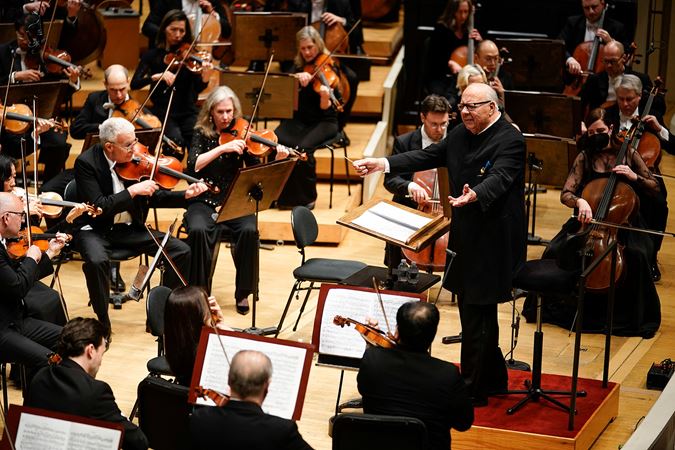 conductor leading orchestra