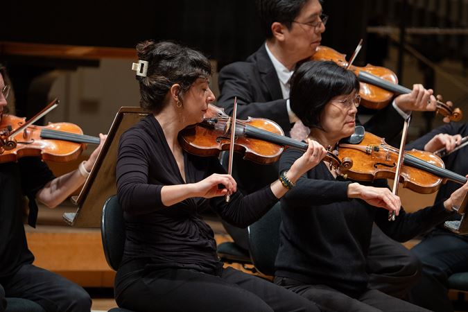 violinists playing on stage