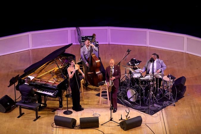Wideshot of the Joshua Redman Quartet and singer Gabrielle Cavassa on stage