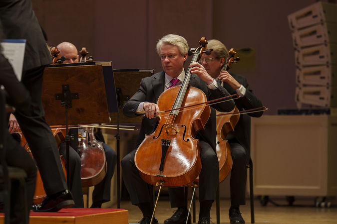 Close up of cellist Richard Hirschl playing on stage