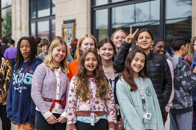 A group of students smiling at the camera outside of Symphony Center on Michigan Avenue
