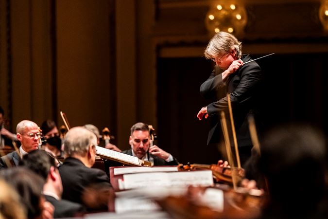 Closeup of Esa-Pekka Salonen conducting the Chicago Symphony Orchestra at the podium