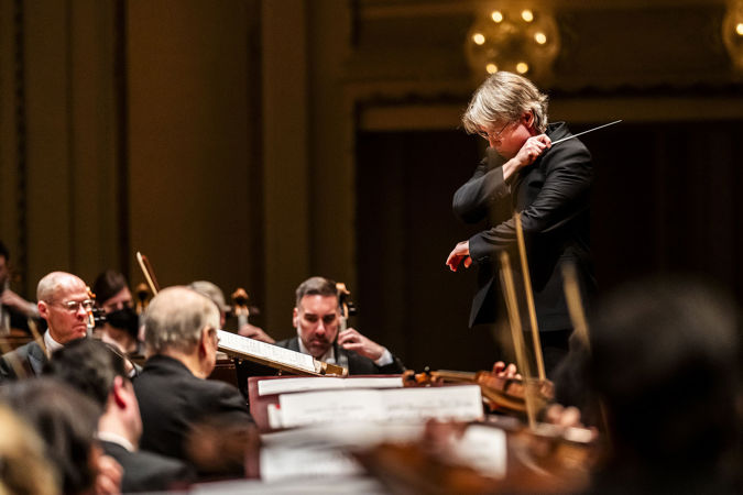 Closeup of Esa-Pekka Salonen conducting the Chicago Symphony Orchestra at the podium
