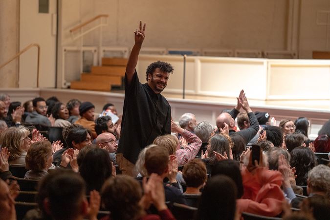 composer Curtis Stewart rises from the audience to accept applause