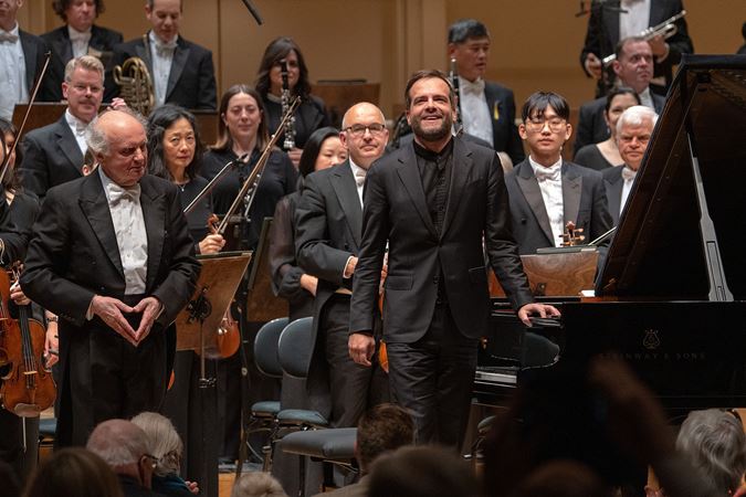 pianist smiles as he takes a bow