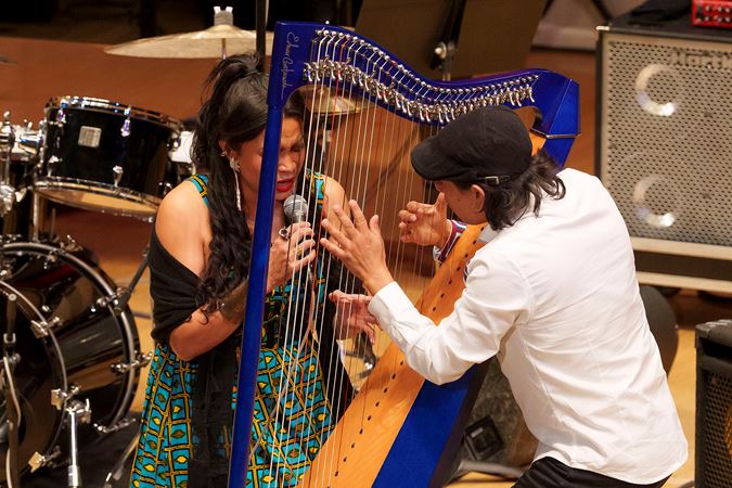 jazz harpist Edmar Castañeda and vocalist Andrea Tierra lean in close during a piece