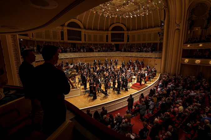 the audience gives the CSO and guest conductor James Gaffigan a standing ovation, as seen from the left side of the box level