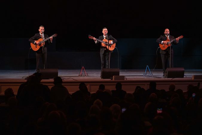 Trío Remembranza performs on stage before an enraptured crowd