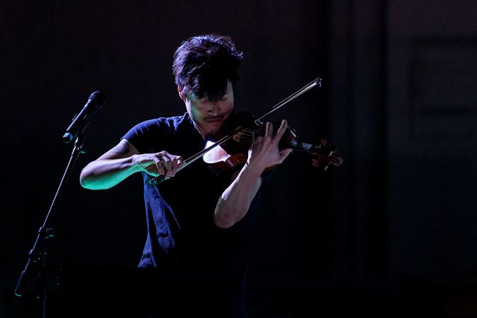 violinist Charles Yang of trio Time for Three performs in shadow
