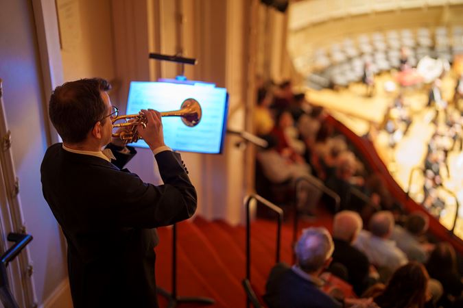 A CSO trumpet player performs from the lower balcony