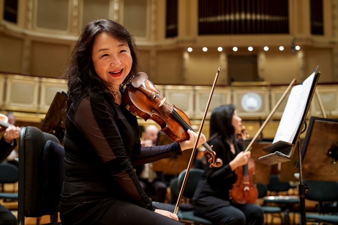 A close up of a CSO violinists