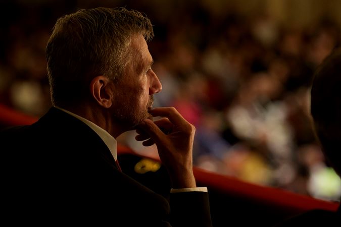 A patron listening intently to the concert from the a box on the Box Level