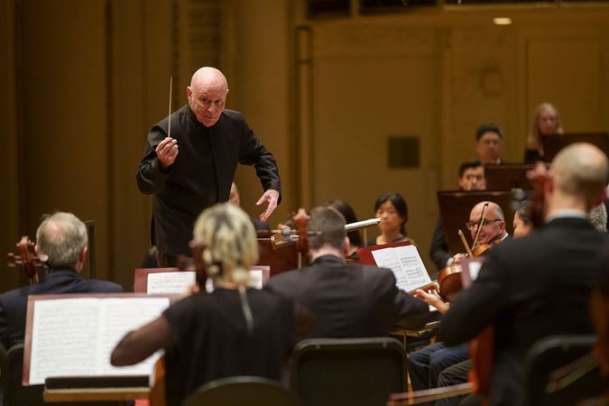 conductor leading orchestra