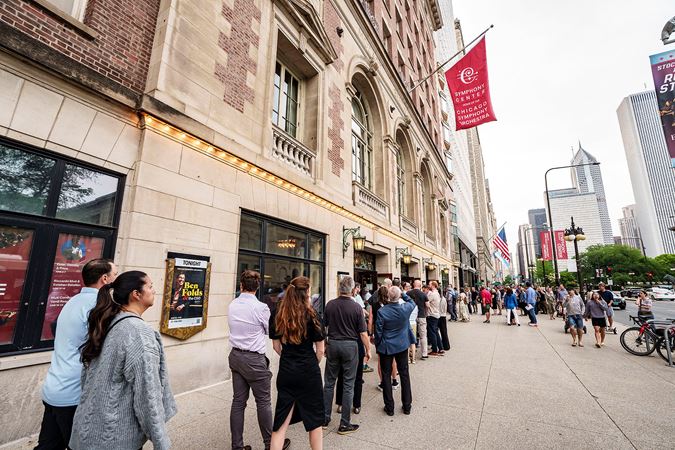 Audiences members wait on the Michigan Avenue entrance to get their tickets scanned