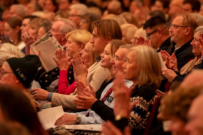 Happy audience members applauding from the Main Floor