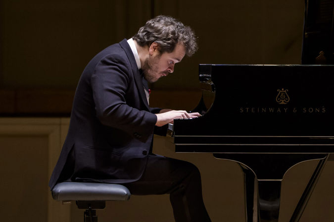 A close-up of Grosvenor at the piano, fingers flying and eyes locked on the keys